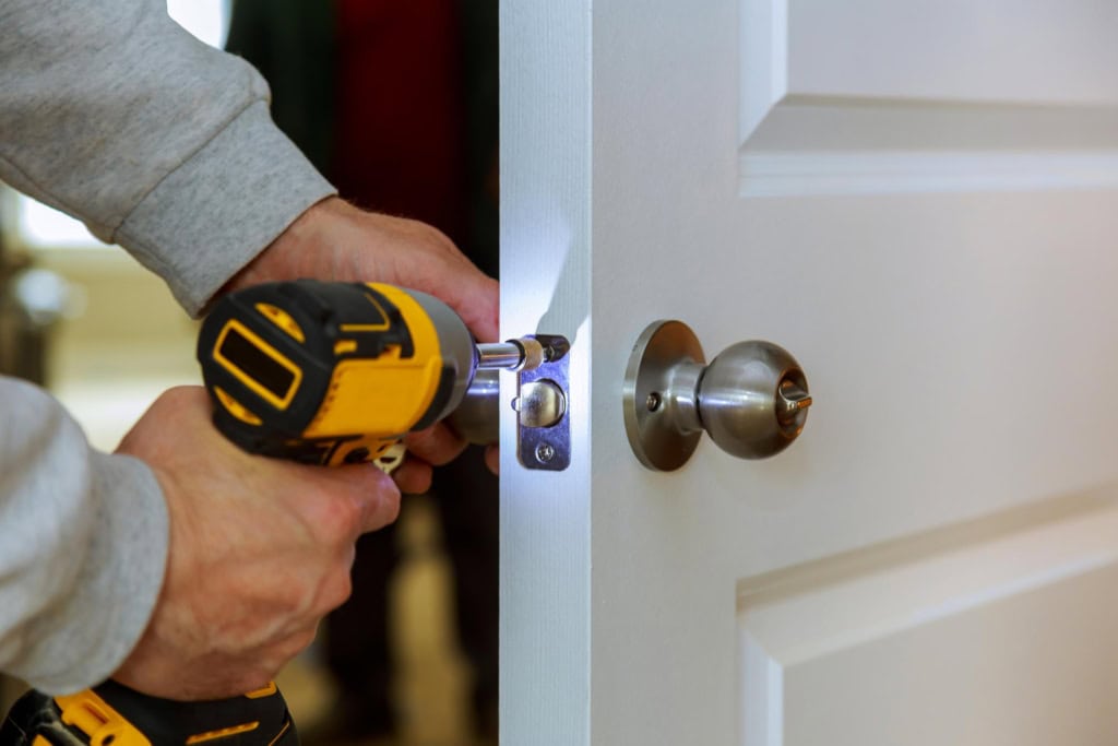 Locksmith fitting a door lock
